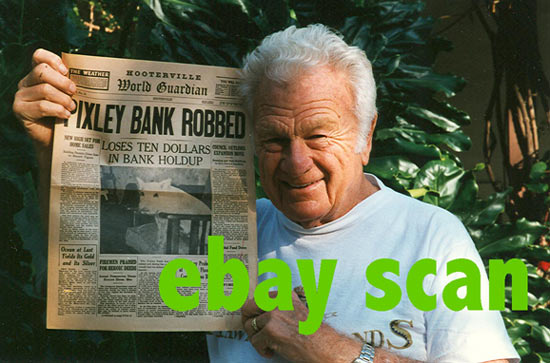 Eddie Albert holds up a newspaper prop from the show